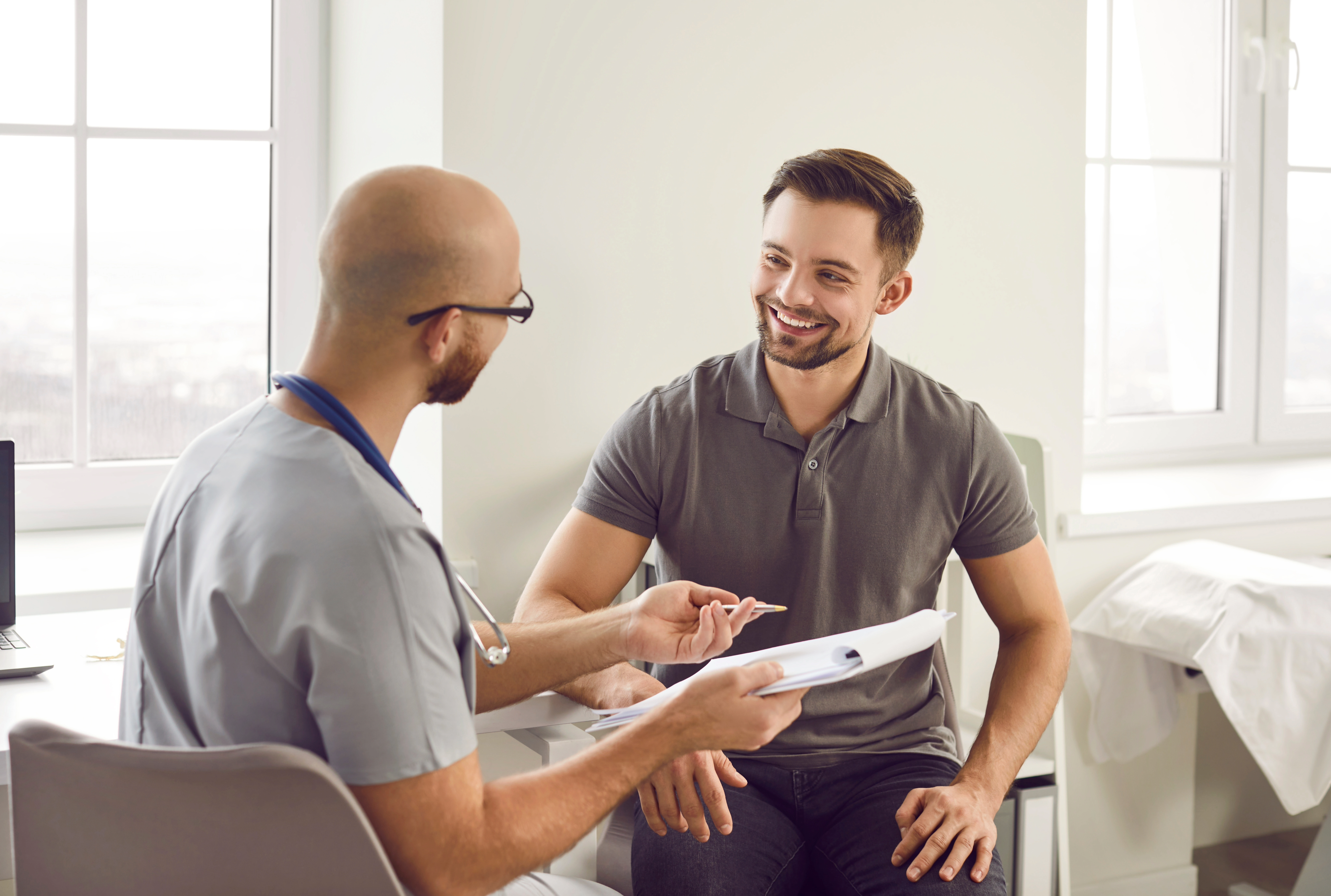 Doctor with a clipboard talking to a patient