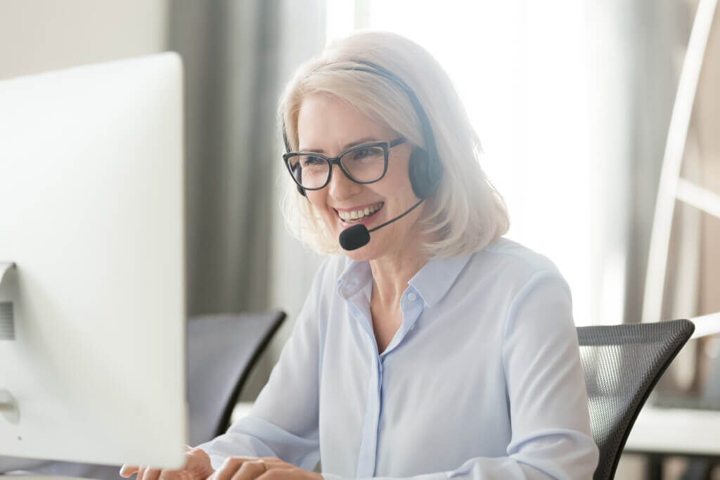 AccessNurse Employee With Headset at Computer