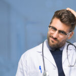 confused doctor scratching his head