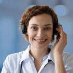 woman smiling holder her headset