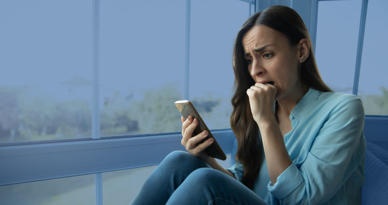 scared woman looking at phone