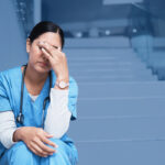 sad nurse sitting on the stairs