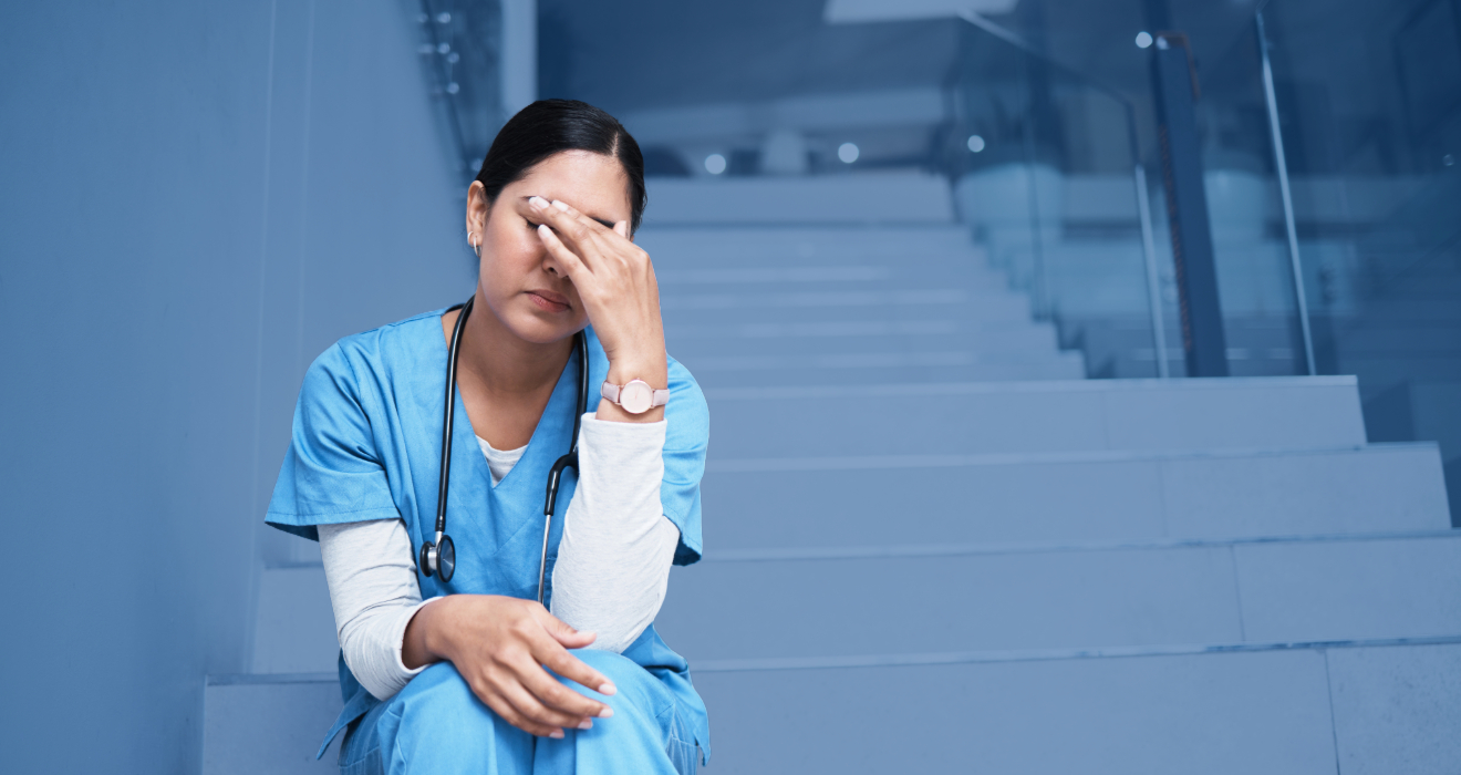 sad nurse sitting on the stairs