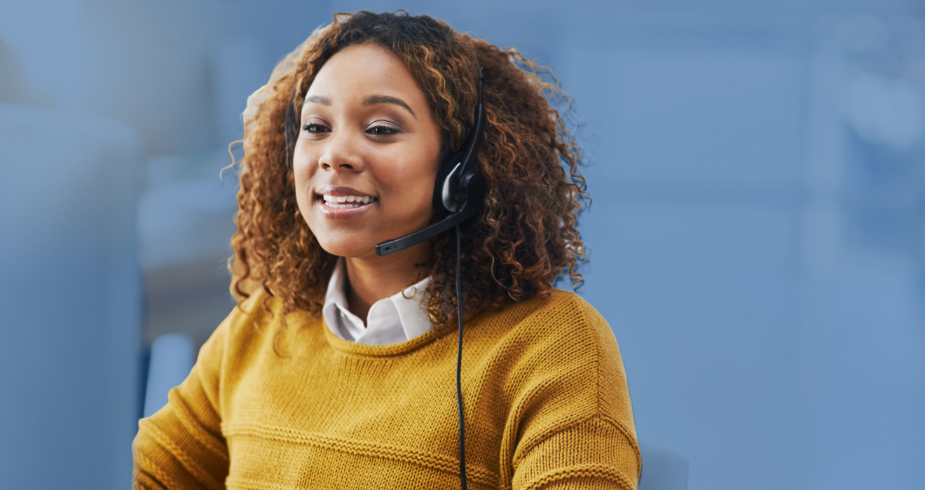 woman in yellow sweater wearing a headset