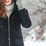 Woman Putting Hood Up Outside in Winter